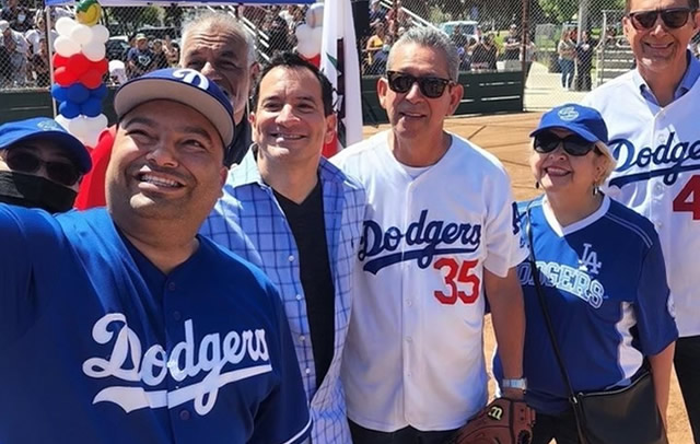 Group photo of Speaker Rendon with constituents wearing Dodgers jerseys
