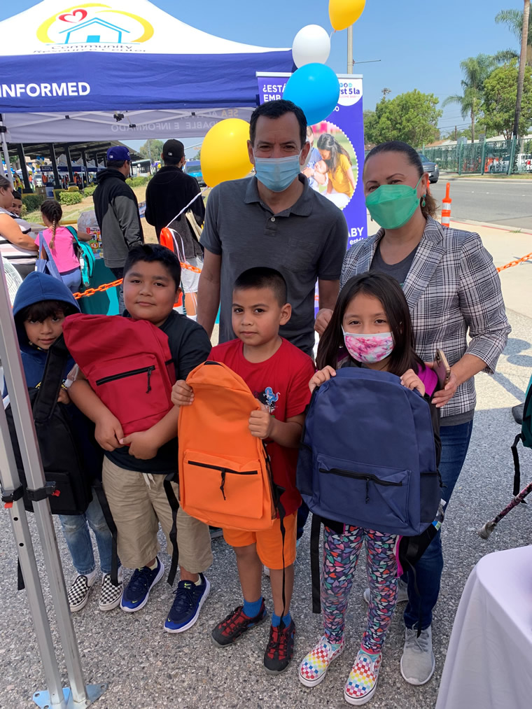 Speaker Rendon with student backpack recipients