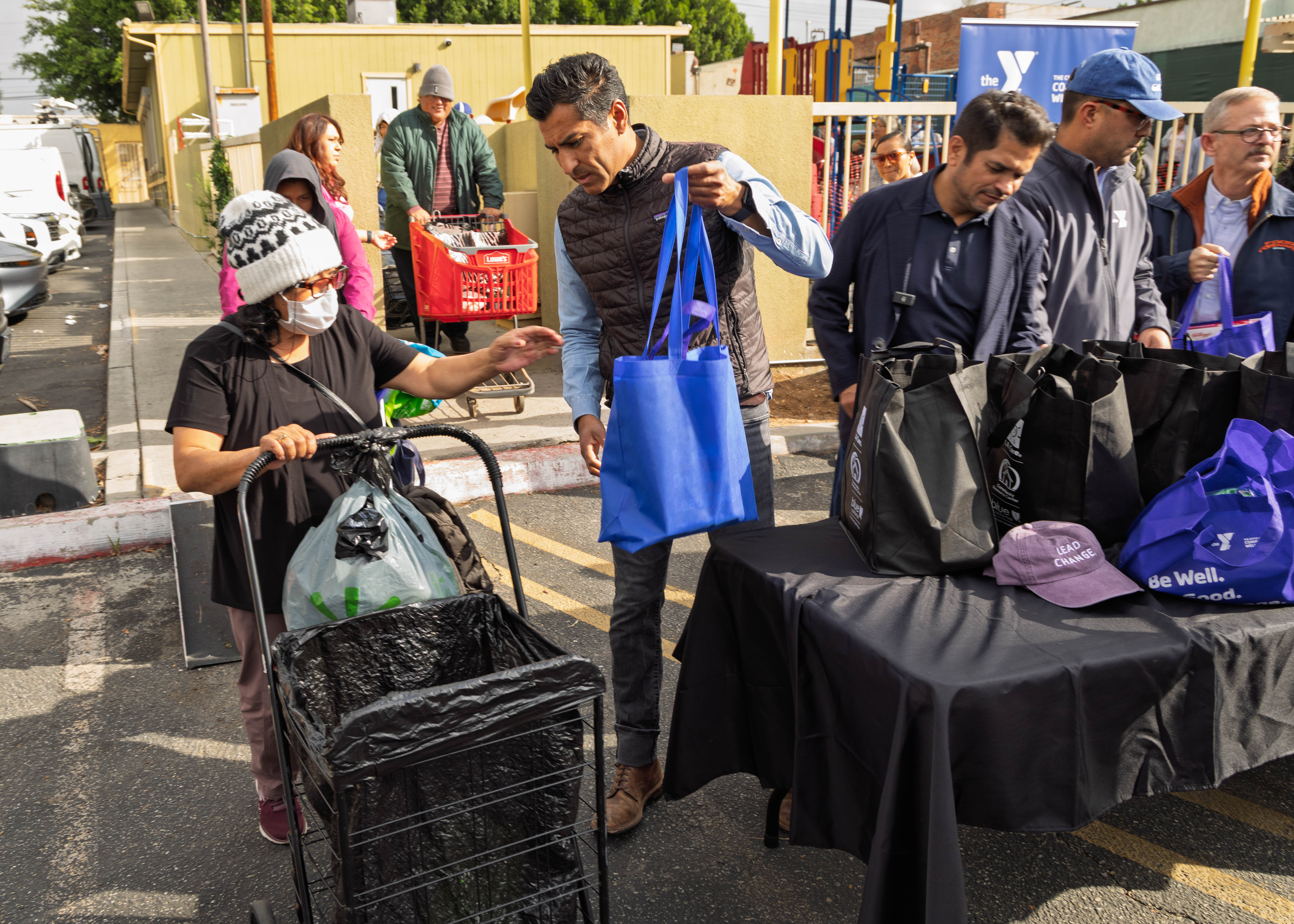 Speaker Rivas hands out groceries.