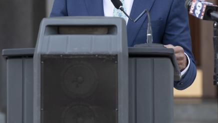 Vertical photo of Assemblymember Robert Rivas speaking at podium