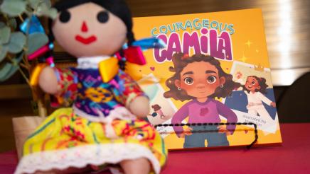 "Courageous Camila" book displayed on table with doll