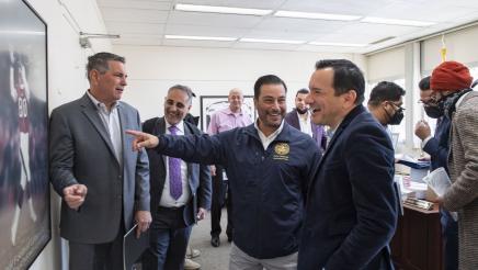 Speaker Rendon and Asm. Villapudua having a light moment while viewing a poster
