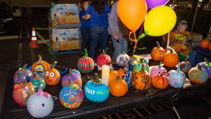 Table containing multiple decorated pumpkins