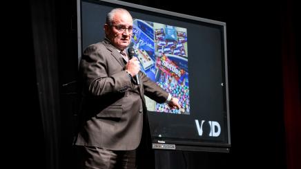 Guest speaker pointing to photo collage of candy and Fentanyl