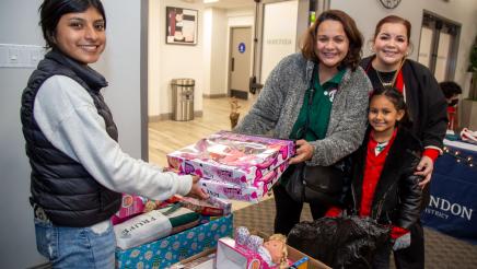 Volunteer distributing toys to family