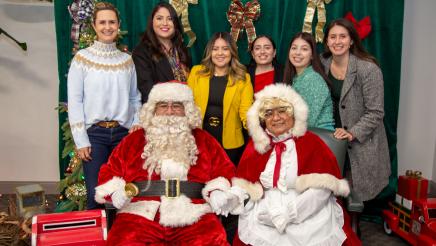 Speaker Rendon's staff posing with Mr. and Mrs. Claus 