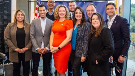 Speaker-Designate poses with colleagues