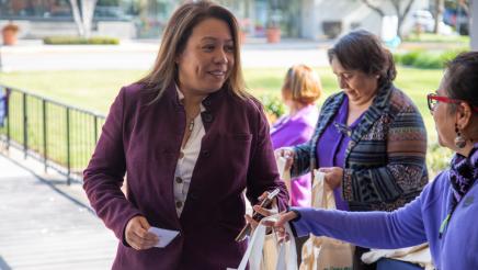 Woman being greeted with gift bags