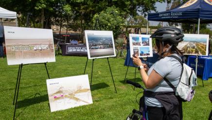 Bike participant taking photos of site plan displays