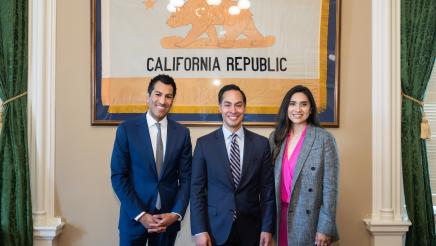 Speaker Rivas, Secretary Castro, and Assemblywoman Cervantes in front of a California flag